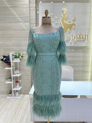 A stunning gold, off-the-shoulder maxi dress with a flowing skirt, perfect for a summer evening party.